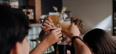 people raising their glasses